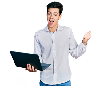 Young hispanic business man working using computer laptop pointing thumb up to the side smiling happy with open mouth