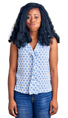 Beautiful african american woman wearing casual summer shirt puffing cheeks with funny face. mouth inflated with air, crazy expression.