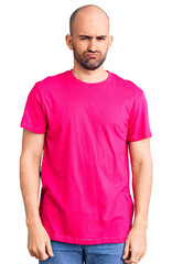 Fototapeta premium Young handsome man wearing casual t shirt depressed and worry for distress, crying angry and afraid. sad expression.