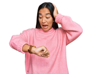 Young asian woman wearing casual winter sweater looking at the watch time worried, afraid of getting late