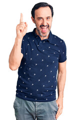 Naklejka premium Middle age handsome man wearing casual polo pointing finger up with successful idea. exited and happy. number one.