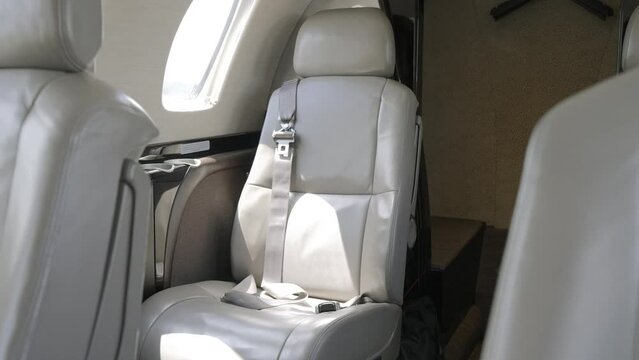 Focused on luxurious leather seats which arranged in comfortable and spacious cabin of plane. Bright lighting creating atmosphere of exclusivity and comfort