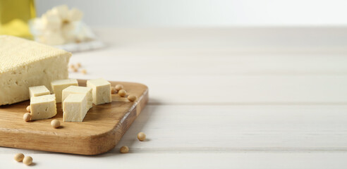 Delicious tofu and soybeans on white wooden table, space for text. Banner design