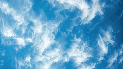 Obraz premium Abstract background of wind shaped soft white clouds against a blue sky