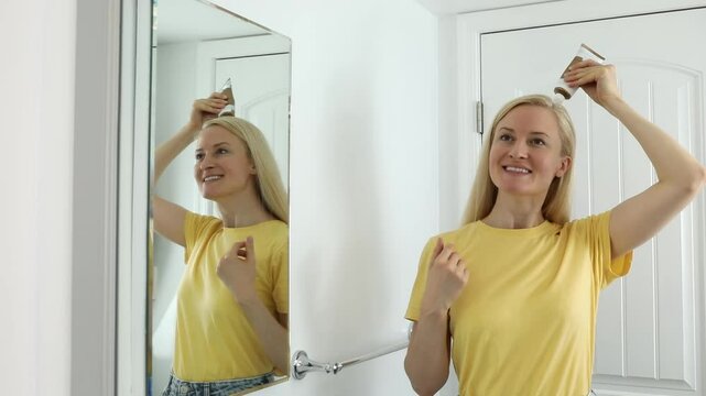 37 yo Caucasian Woman Applies Scalp Peeling, Scrub on Head Skin, Hair. Dandruff. Blond White Female Holds Tube with Purifying and Soothing Cosmetics Product. Horizontal Video. Haircare. Slow Motion