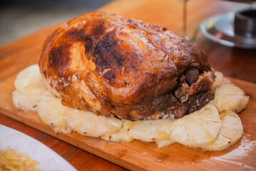 Roasted Fresh Ham served with pineapples.