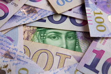 Top view purple and green paper banknote 50 GEL, 100 lari. Photo of cash money of Georgia. Female eye of Queen Tamara close up. Currency exchange, travel, tourism, wealth, tax. Woman face on bank note