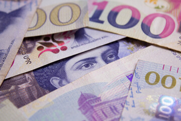 Male eyes watching from stack of cash money hole. Georgian paper banknotes. One hundred lari. 100 GEL. Concept of mystery, secret, loan, currency exchange, debt. Shota Rustaveli looks. Bank note. Bill