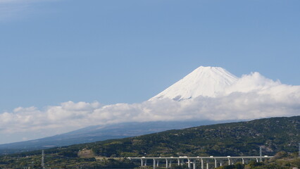 Clear sky and Mt. Fuji. A car running on the road.