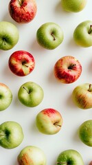 Top view of green and red apples on white background, healthy eating concept