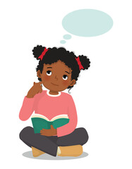 Cute little African girl thinking dreaming while reading book sitting on floor
