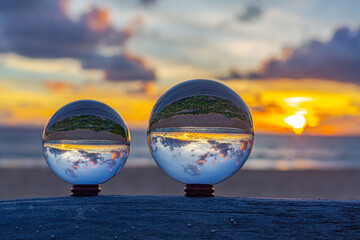 captured using a crystal ball to capture the colorful sky. stunning sunset at the sea in twilight....