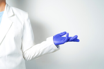 Doctor or nurse hand in sterile gloves in holding position isolated on white