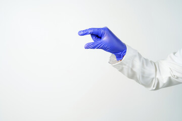 Doctor or nurse hand in sterile gloves in holding position isolated on white