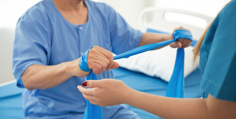 Elderly Patient Receiving Physical Therapy from Young Female Therapist in Hospital Setting
