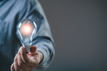 businessman hold light bulb inspired by innovative business idea, male boss or director motivated...