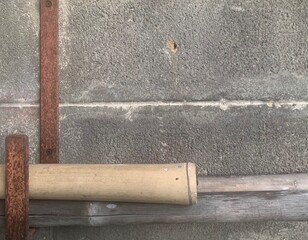 Cement block wall with metal hanger and bamboo wood