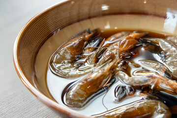 Fototapeta premium Close-up of Teochew Marinated Raw Shrimp on the table, Chinese food