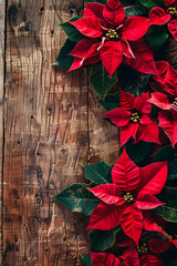 A close-up of red poinsettias arranged on a rustic wooden background, creating a festive and traditional holiday decoration perfect for Christmas themes.