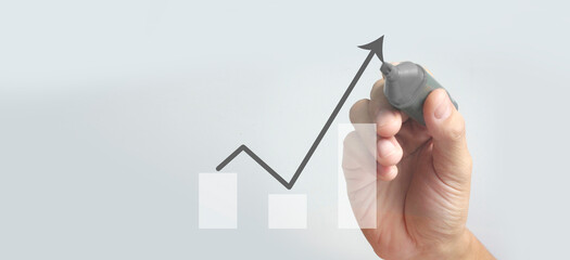 Male hand drawing graph chart showing business profit growth increasing