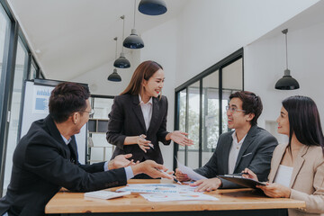 Professional team, including businessmen and businesswomen, engages in a strategy meeting. They discuss marketing, analyze financial data, and brainstorm investment plans using charts, graphs,