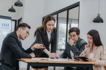 Professional team, including businessmen and businesswomen, engages in a strategy meeting. They discuss marketing, analyze financial data, and brainstorm investment plans using charts, graphs,