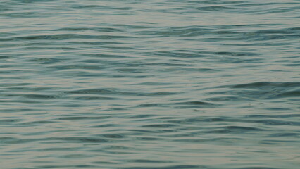 Calm Tranquil Sea Surface. Natural Backlit. Beautiful Blurry Water Background.