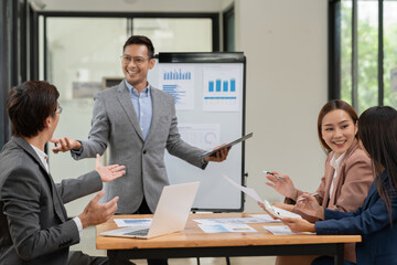 Asian Business Group Chat about graph work Present in meetings, in the office