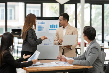 Group of business people meeting and present work on the board