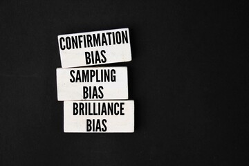 White wood with the three words Confirmation Bias, Sampling Bias, and Brilliance Bias. White wood with the three words Confirmation Bias, Sampling Bias, and Brilliance Bias. Three types of bias can be