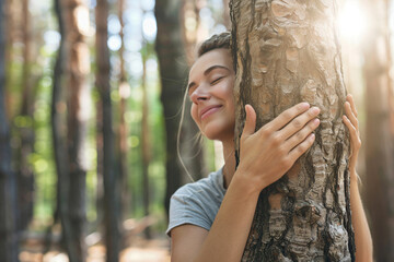 a woman hugging a tree in a forest