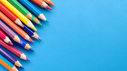 Colorful pencils in various hues against a blue background
