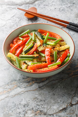 Summer Stir fry zucchini, green onions and bell pepper close-up in a bowl on the table. Vertical
