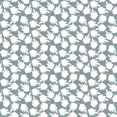 Silhouettes of leaves in seamless pattern. White leaf on a gray background