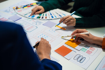 UX developer and ui designer brainstorming about mobile app interface wireframe design with customer breif and color code, User experience concept..