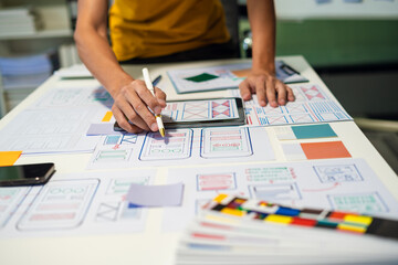 UX developer and ui designer brainstorming about mobile app interface wireframe design with customer breif and color code, User experience concept..