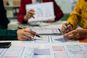 UX developer and ui designer brainstorming about mobile app interface wireframe design with...