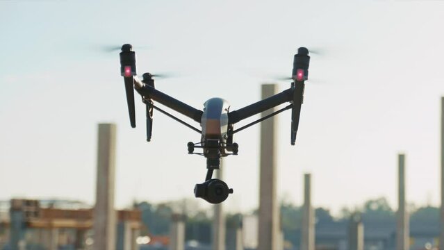 Shooting of drone flying over construction site. Topographical survey for initial site assessment. Copter in air. Geodesy concept. Outside. Daytime