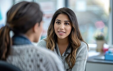 A female psychologist listens intently to her client in an office setting