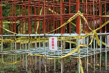 A jungle gym wrapped in yellow tape and marked forbidden to use