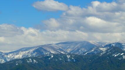 Forest In The Snowy Mountains. Snow-Capped Mountains And Forest Bathed In Bright Sun. Timelapse.