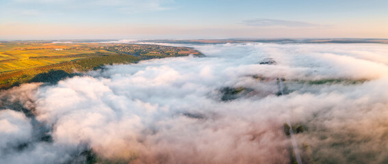 Peaceful bird's eye view of a misty valley covered in fog. Dniester canyon, Ukraine, Europe.