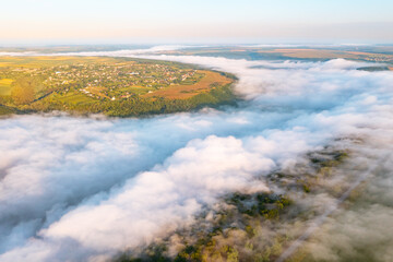 A gorgeous bird's eye view of the valley covered with thick fog.