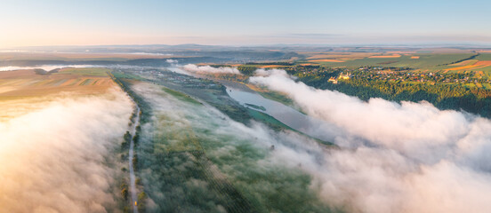 Gorgeous top view of the road passing through the agricultural lands.