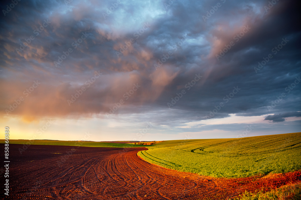Aufkleber Multicolored storm clouds illuminated by rays at sunset.