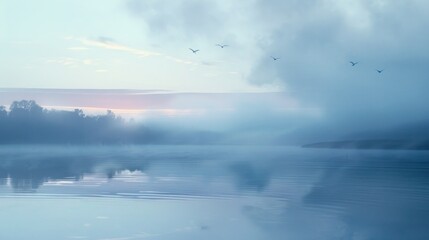 Obraz premium A serene lake at dawn, with mist rising from the water and birds taking flight.
