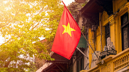 A red national flag of Vietnam stands above the streets of Hanoi. Symbol country