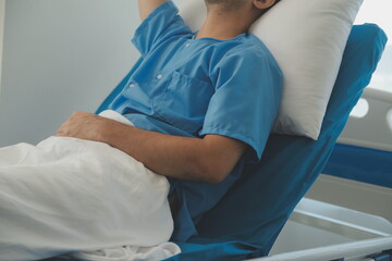 Obraz premium Seriously Ill Man Lying on a Bed in the Hospital. Monitors Show His Vital Signs. Ward is Clean and New.