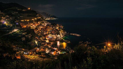 Fototapeta premium A stunning aerial view of a coastal town at night, illuminated by vibrant lights, with the calm sea reflecting the serene ambiance.