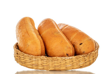 Three fragrant sweet buns on a straw plate, close-up, isolated on a white background.